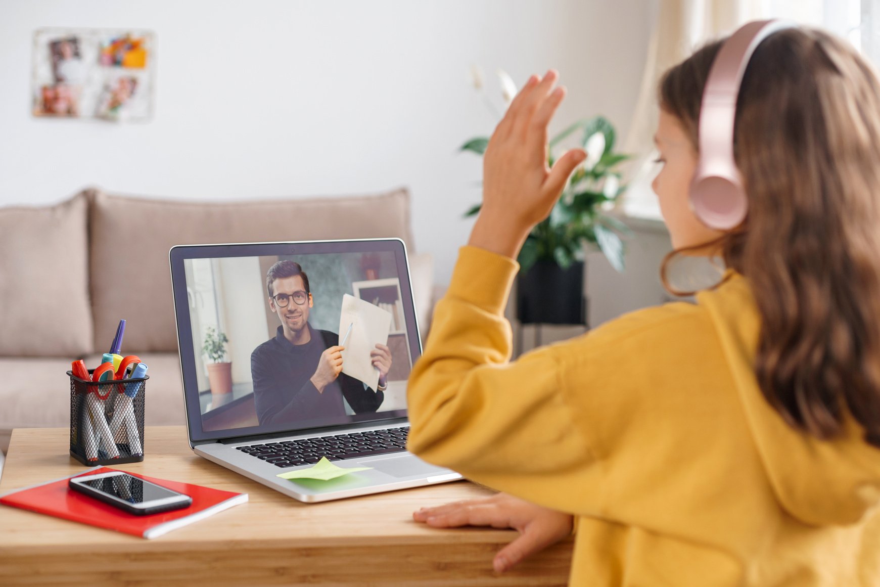 School girl learning from home with personal online tutor