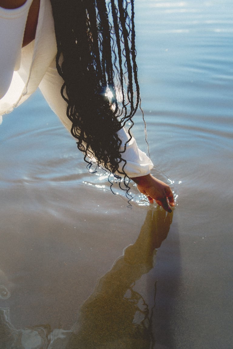 Calming Water Person Reaching for Water at a Lake